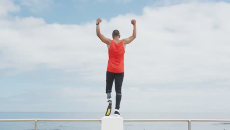 Rear-view-man-with-prosthetic-leg-at-the-beach