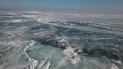 flying over lighthouse to reveal the ice and shoreline on frozen lake erie in january