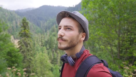 young tourist is walking looking into the valley.