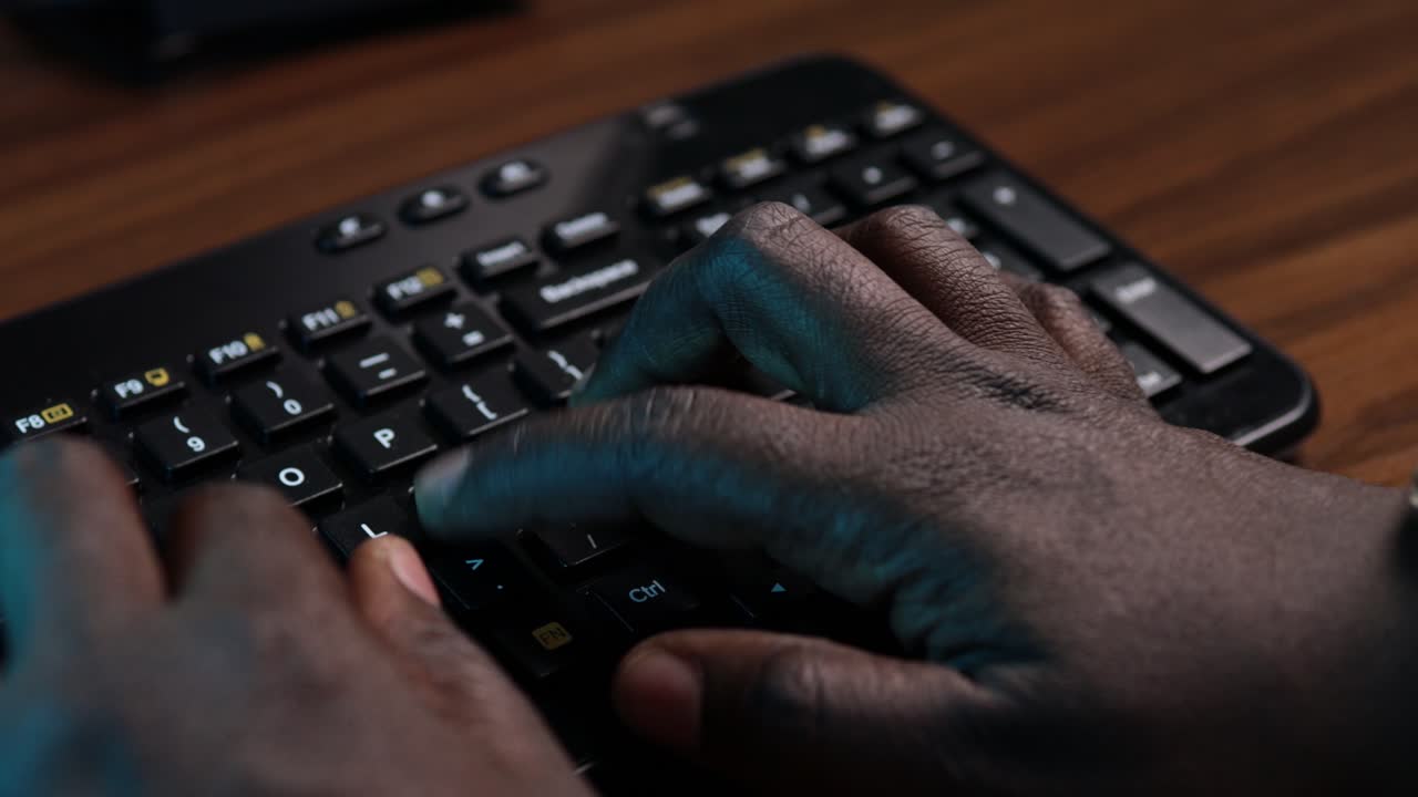 African American man typing on a computer keyboard