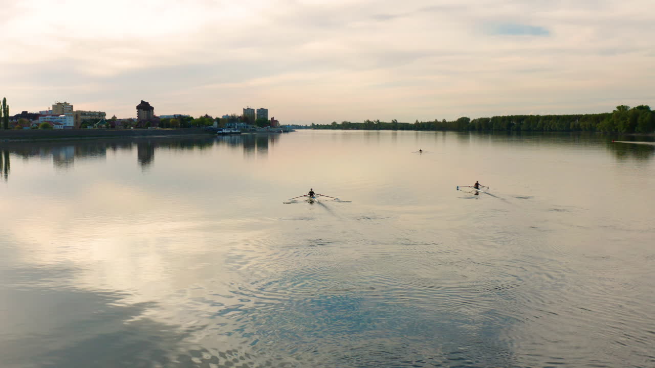 People rowing their boats and sees the beautiful sunset in Danube River, Vukovar Croatia