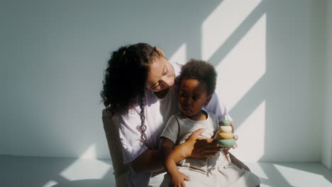 mother and child playing with stacking rings