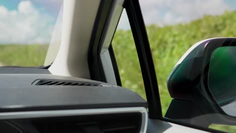 Close-up-shot-of-interior-of-a-car-showing-dashboard-and-side-mirror