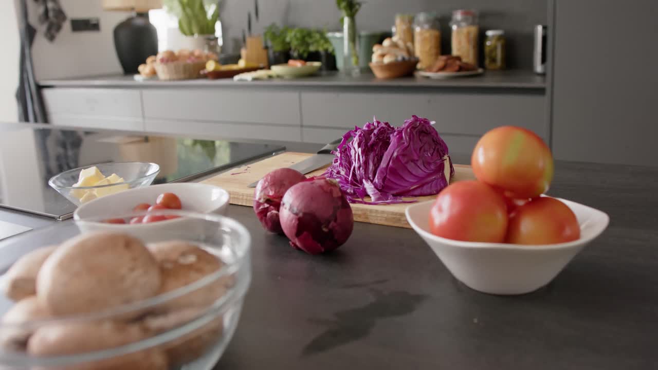 Close up of food in bowls on countertop in kitchen, slow motion