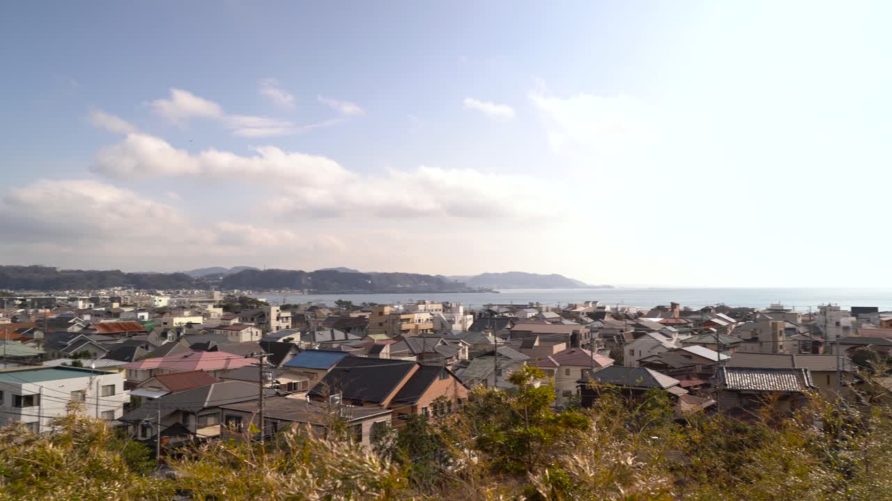 Houses Built In The Small Japanese Seaside Town Of Enoshima In Japan With Bright Sun In The Background - Right Panoramic Shot