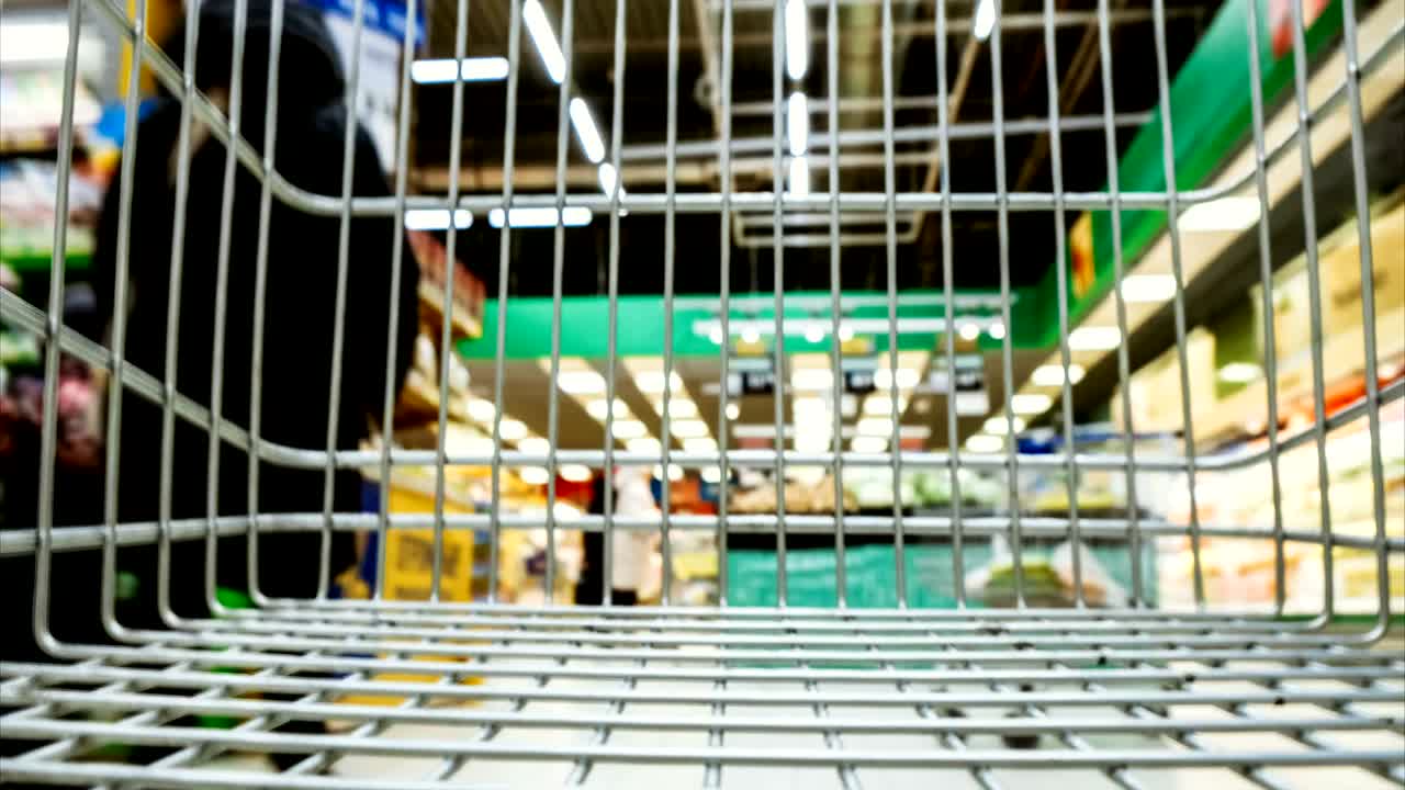 un carrito de comestibles vacío conduce un supermercado de comestible, lapso de tiempo