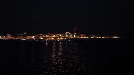 still panoramic view of city centre of alghero port at night