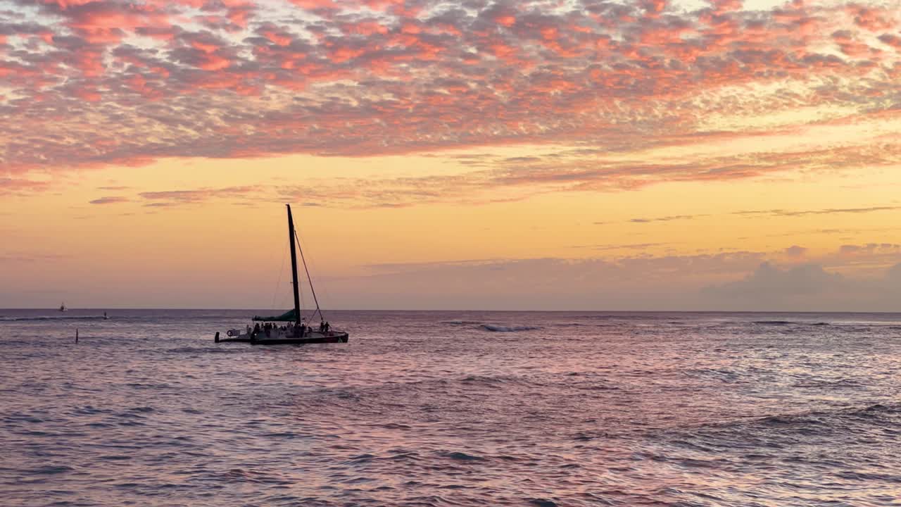 Sailboat glides at sunset in Oahu, Hawaii, calming serene ocean view