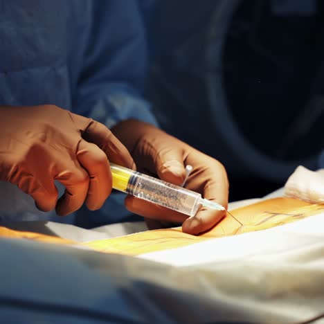 hands of the surgeon close-up. modern equipment in operating room. medical team performing operation