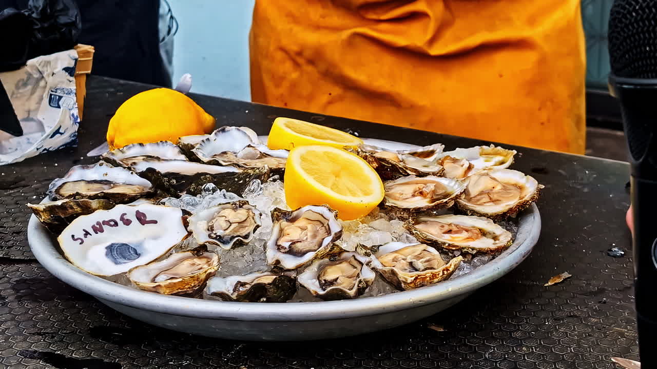Delicious iced oyster with lemon ready to serve, close up view
