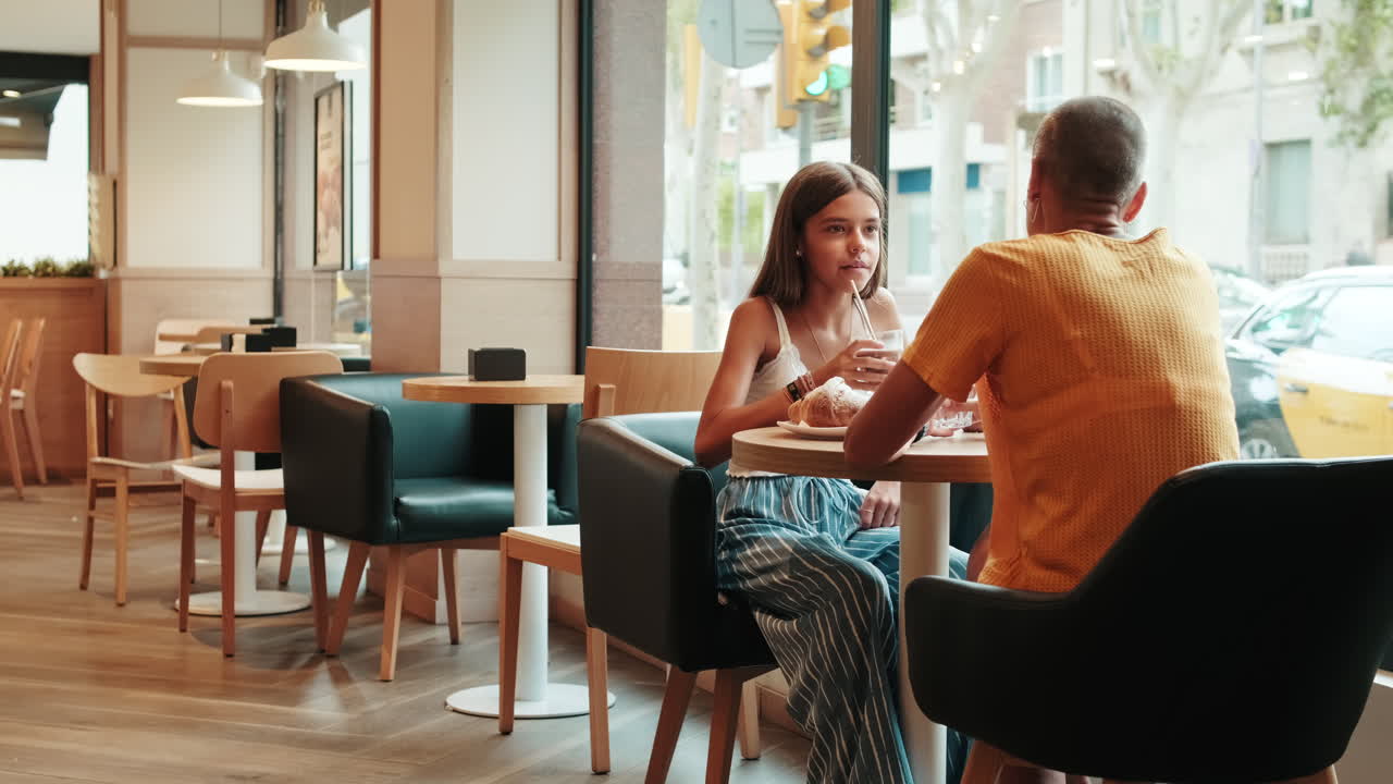 Woman Listens To Friend or Daughter In Cafe