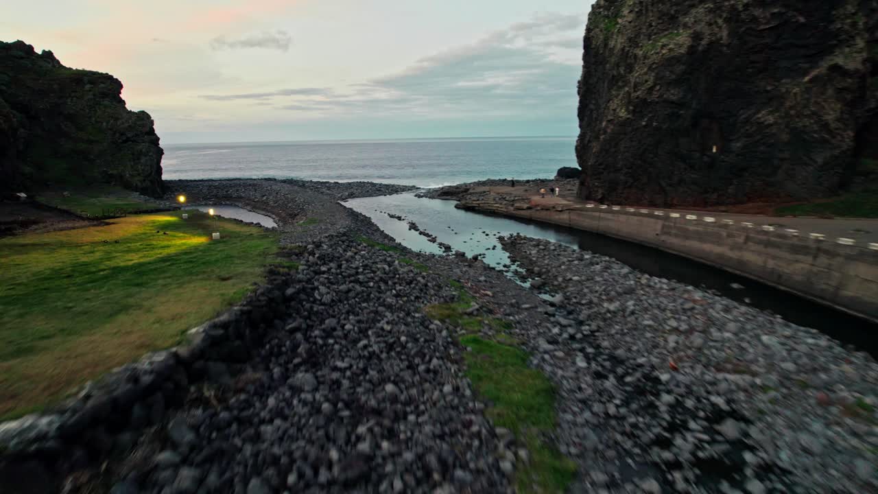 Volcanic Coastline at Sunset with People