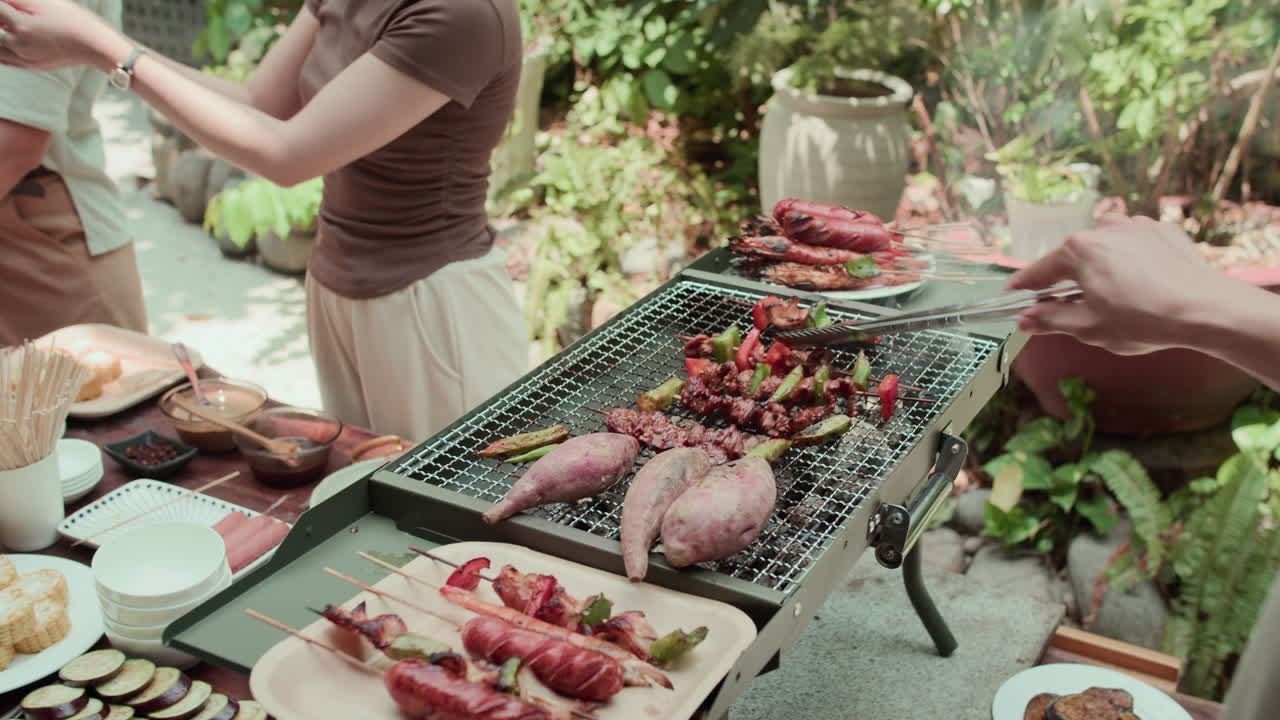 Unrecognizable Man Cooking Barbecue during Party with Friends