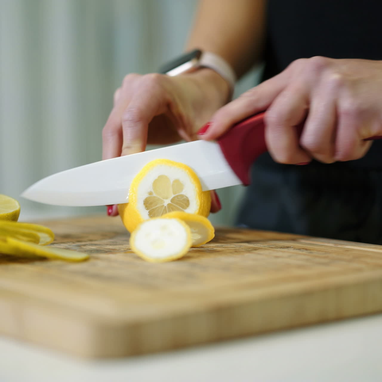 Female hands cutting fresh juicy lemon on a wooden kitchen board. Healthy lifestyle. Fresh fruits. Square video