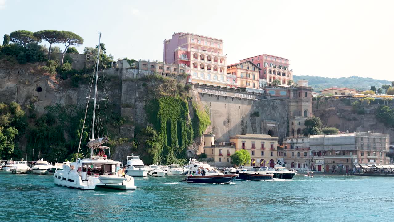 Boats docked near a scenic cliffside pier