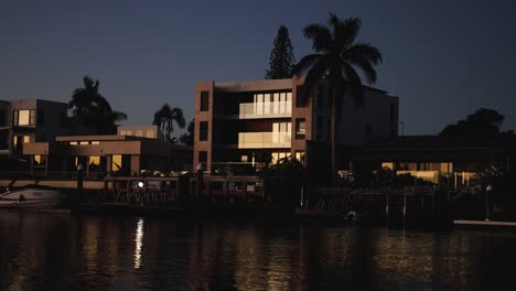 time-lapse of evening light over waterfront buildings