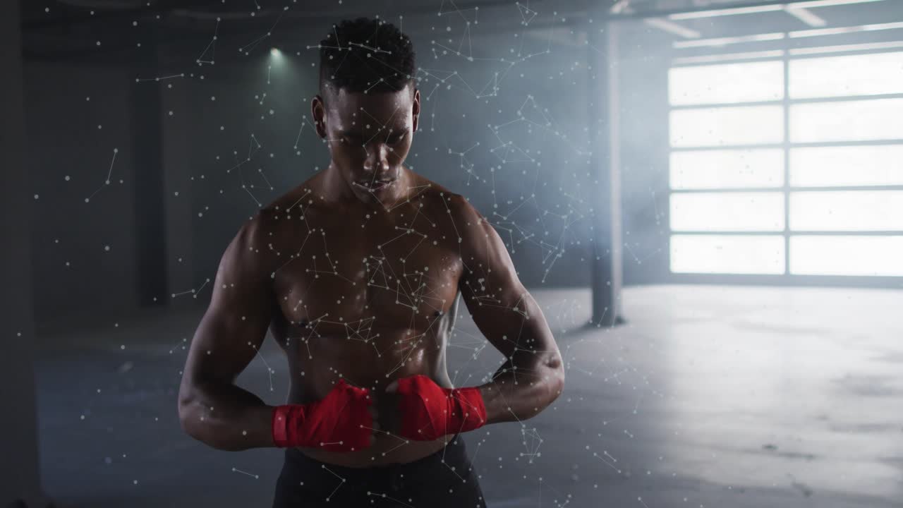 Man looking down, wrapping red wraps in boxing gym, particle overlay over torso preparing for fight