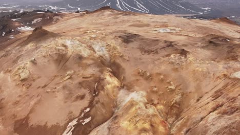 steam rising over the slopes of namafjall mountain, geothermal area in reykjahlid, iceland. - aerial shot