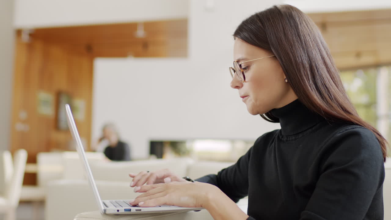 Woman working on a laptop in a modern living room