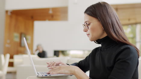 woman working on a laptop in a modern living room