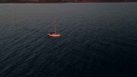 sailboat cruising at sunrise at the saint lawrence gulf near the pointe saint-pierre in quebec, canada