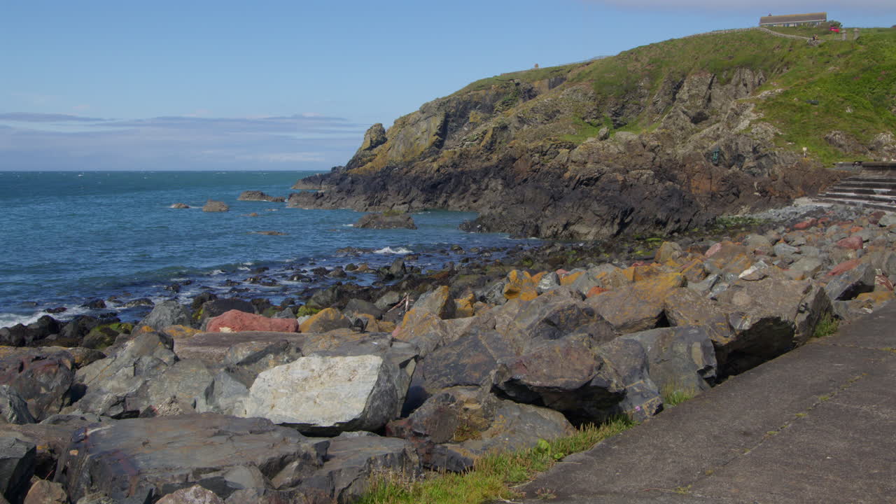 looking north across the rocky seashore at portPatrick harbour.