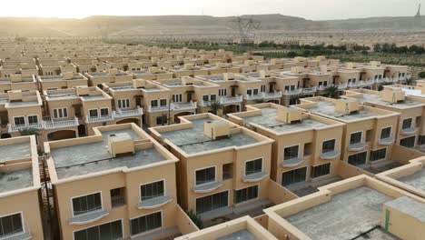 aerial drone view of rows of identical houses at sunset in bahria town, karachi, pakistan