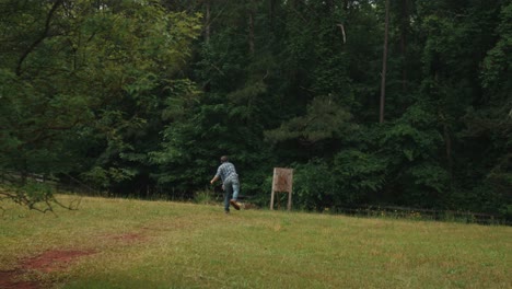 Slow-motion-of-modern-sport-of-axe-throwing-involves-a-competitor-throwing-an-axe-at-a-target