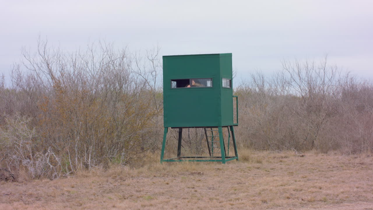 Wide shot of person in hunting blind