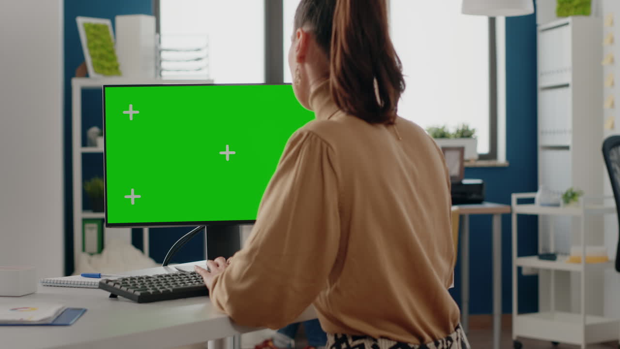 Close up of person using green screen on computer