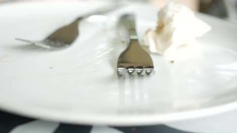 empty plate with utensils and napkin