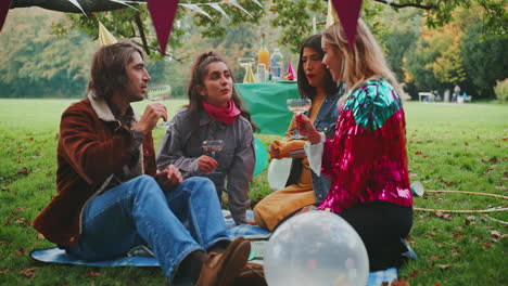 friends having a picnic party in a park