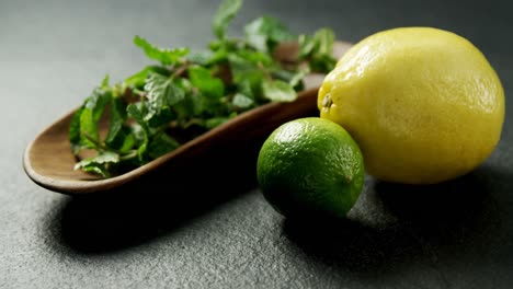 Mint-leaf-and-sweet-limes-on-black-background-4k