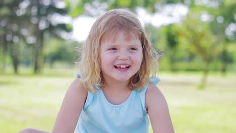 little girl in the park , laughing