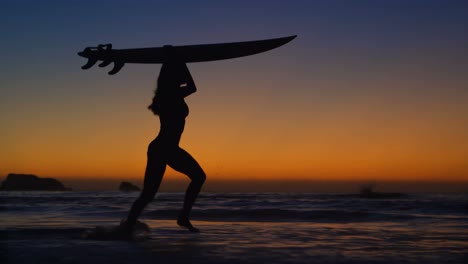 Female-surfer-walking-with-surfboard-in-the-beach-4k
