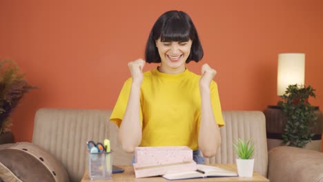 happy and joyful woman opening gift package.