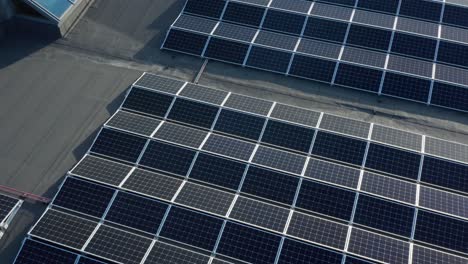Drone Aerial View of Solar Panel Array Installation on Roof of Modern Building