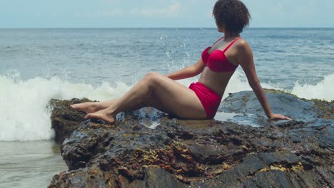 witness a girl in her teens, donned in a bikini, on a bright and sunny white sand beach