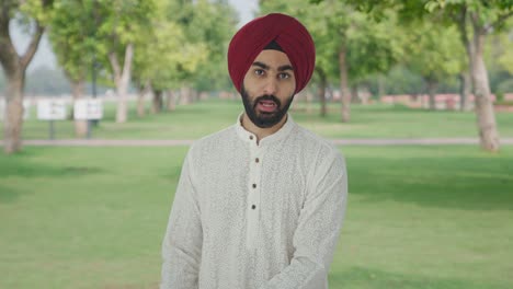 angry sikh indian man shouting on someone in park