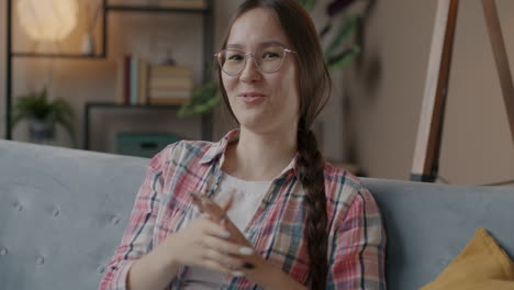 smiling young woman sitting on a couch