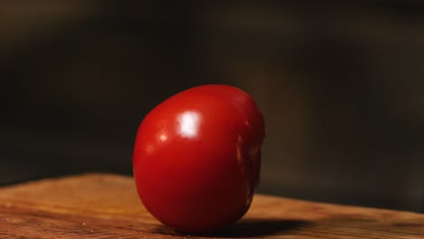 red tomato on a cutting board