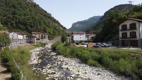 Drone-taking-off-in-Urzainqui-and-flying-above-the-river-and-village-in-the-Roncal-Valley