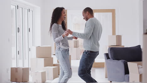 loving couple dancing together as they celebrate moving into new home