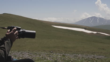 a person with modern camera sitting on a