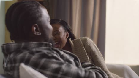 young couple relaxing at home sitting on sofa talking together 11