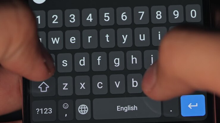 Capture a close-up shot of fingers typing on a smartphone keyboard