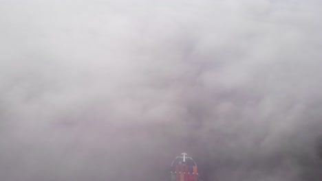 cargo ship travelling by the river through fog at zwijndrecht, netherlands