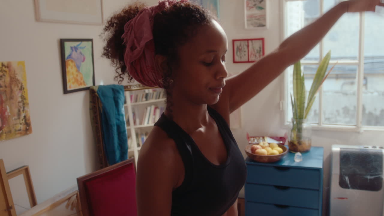 Pretty African-American Girl Dancing at Home and Winking on Camera