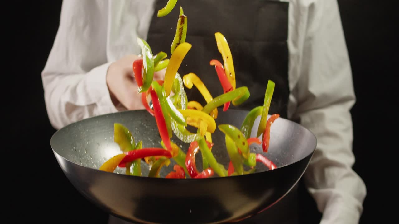 Chef Stir-Frying Colorful Peppers in Wok
