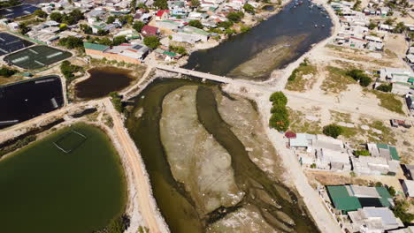 Aerial-view-of-Son-Hai-shrimp-breeding-farm-in-freshwater-pool,-drone-fly-above-remote-fisherman-village-in-Vietnam,-rural-agricultural-area-of-Asia